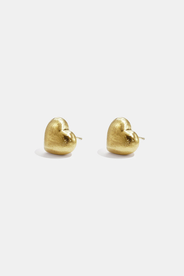 Puces d’oreilles cœur bombé dorées Lumé sur fond clair