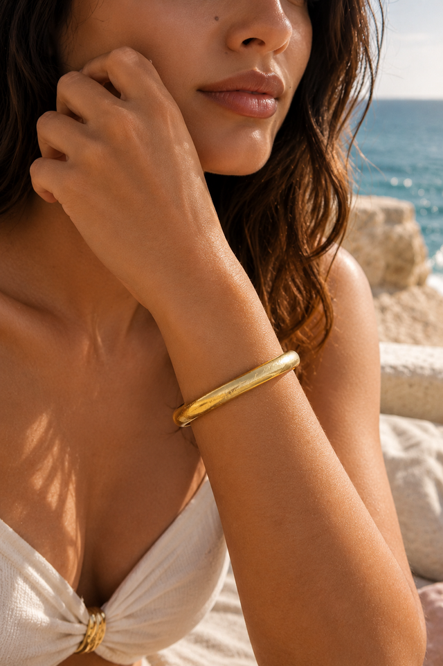 Bracelet jonc texturé doré Lumé porté au poignet par une femme
